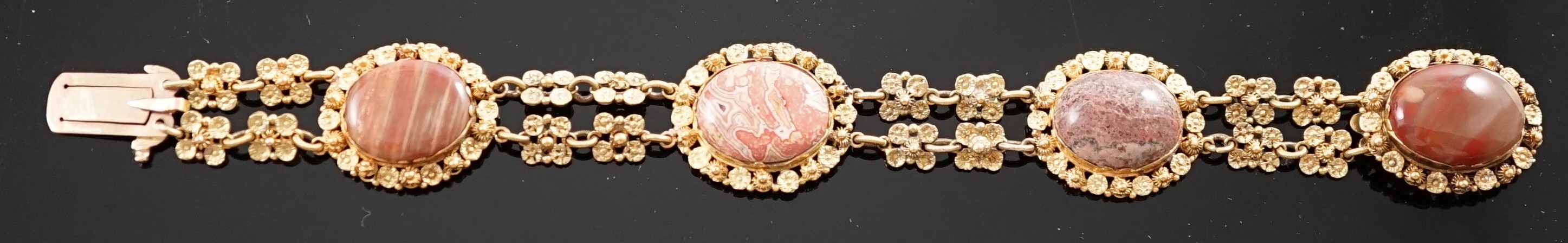 An early 19th century gold and four stone oval cabochon hardstone set bracelet